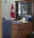 Prime Minister Mark Carney prepares for a meeting with chief executive officers of the automotive industry in his office in July 2025.