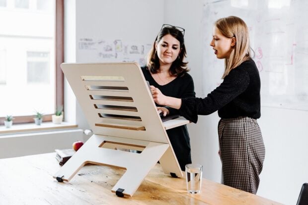 A picture of two women at a standing desk