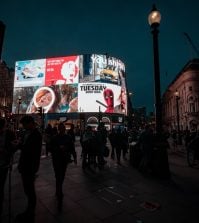 A photo of crowds around Picadilly Circus in London