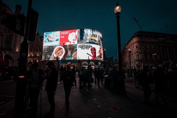 A photo of crowds around Picadilly Circus in London