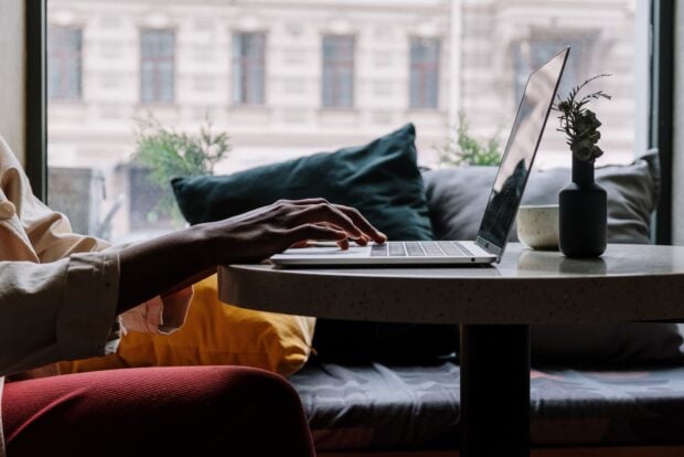 A person at a home desk with a laptop