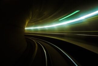 A dark lit tunnel bending to the left